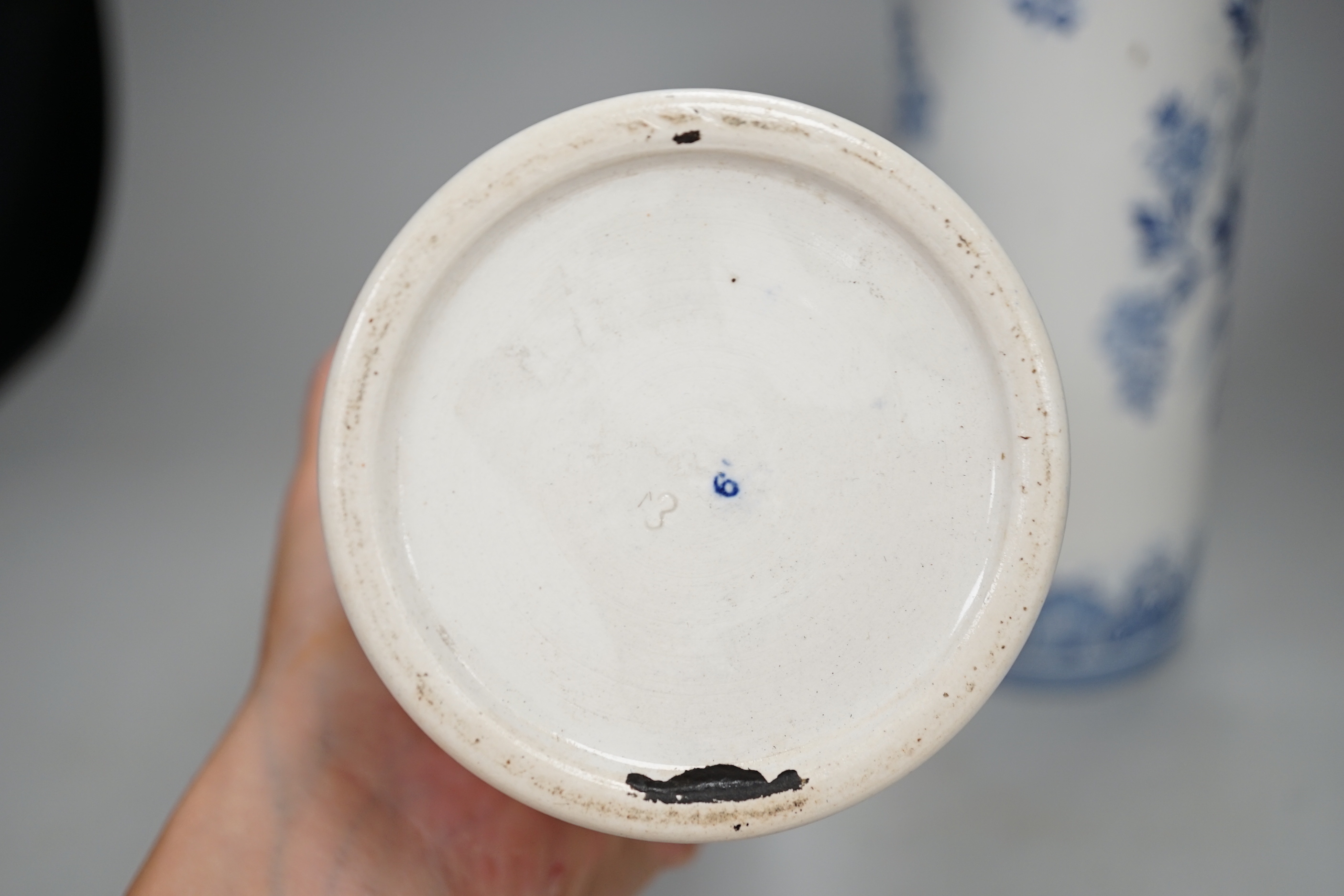 A pair of Delft blue and white cylindrical vases, each decorated with boats, 30cm high